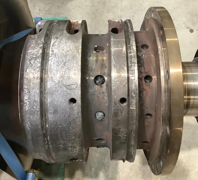 Damaged stuffing box with heat discoloration and worn sealing lands