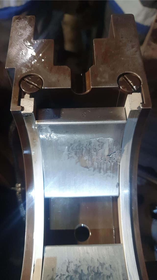 Damaged white metal lining on the drive-end turbine bearing before refurbishment