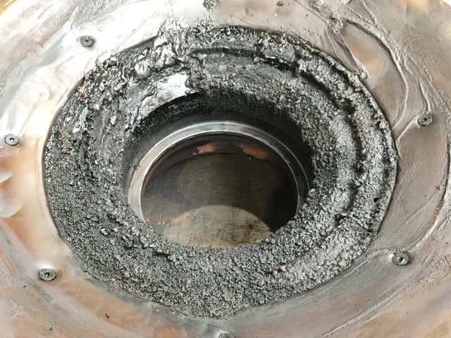 Damaged labyrinth seal seat with heavy erosion and oil-carbon build-up
